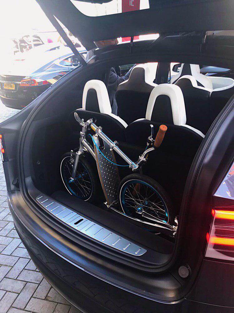 Tesla Model X and kick scooter, evs and adult scooter, park and ride, reduce air pollution