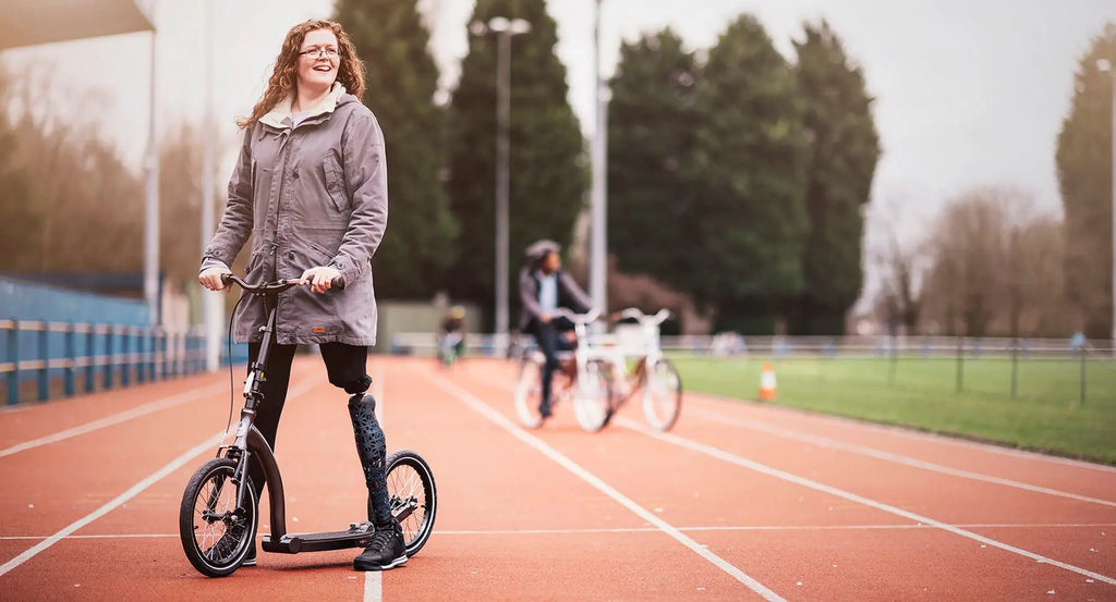 Amputee with folding adult commuter scooter